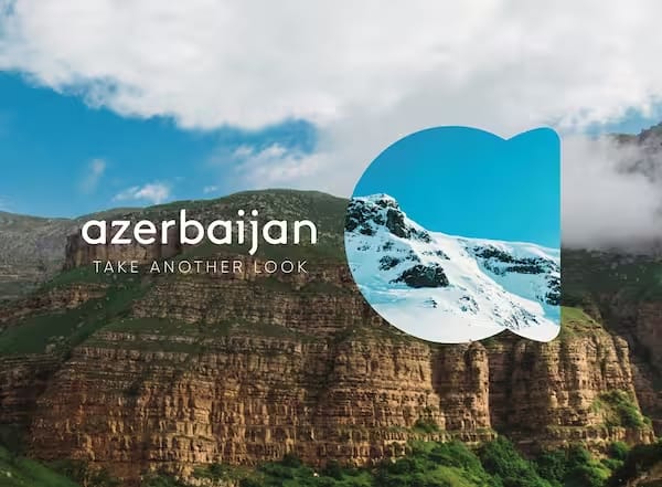 An example of the destination marketing for Azerbaijan's Tourism Board. In the background is a mountain with the phrase 'Azerbaijan: Take another look'. To the centre right is a visual overlay of snowy mountains, showing the multitude of possibilities in Azerbaijan.