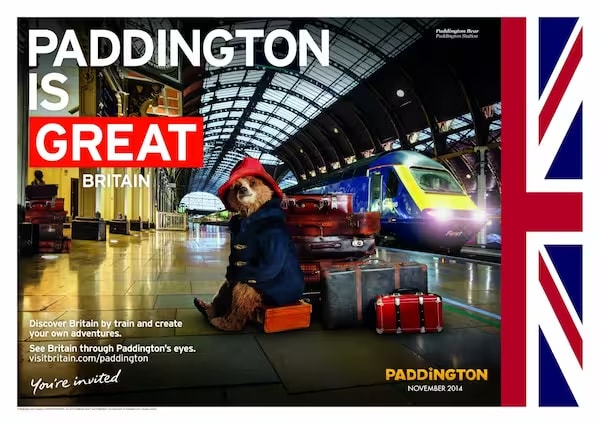 An example of the nation brand marketing of the GREAT Britain campaign. The advert says 'Paddington is GREAT' and has a photo of Paddington Bear sat by a pile of suitcases at Paddington station. On the right hand side there is a segment of the Union Jack.